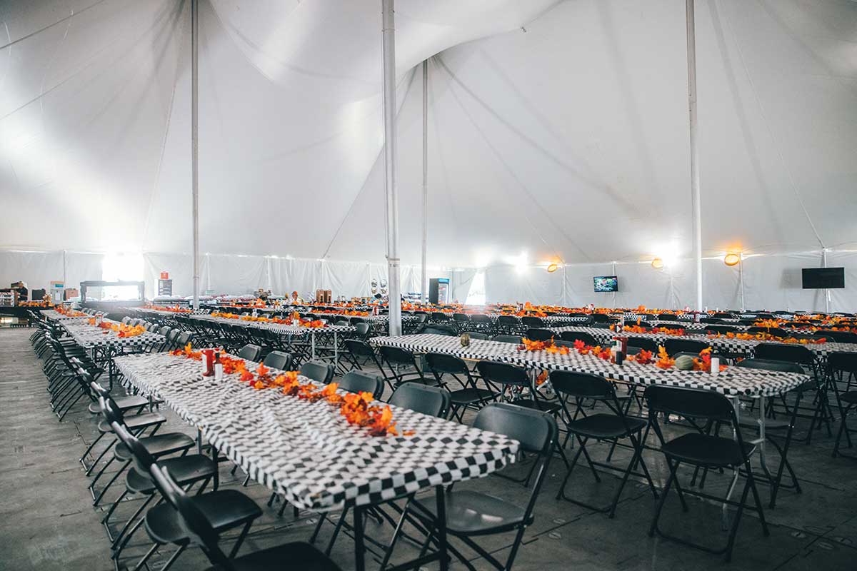 A dining tent interior set up for a meal.