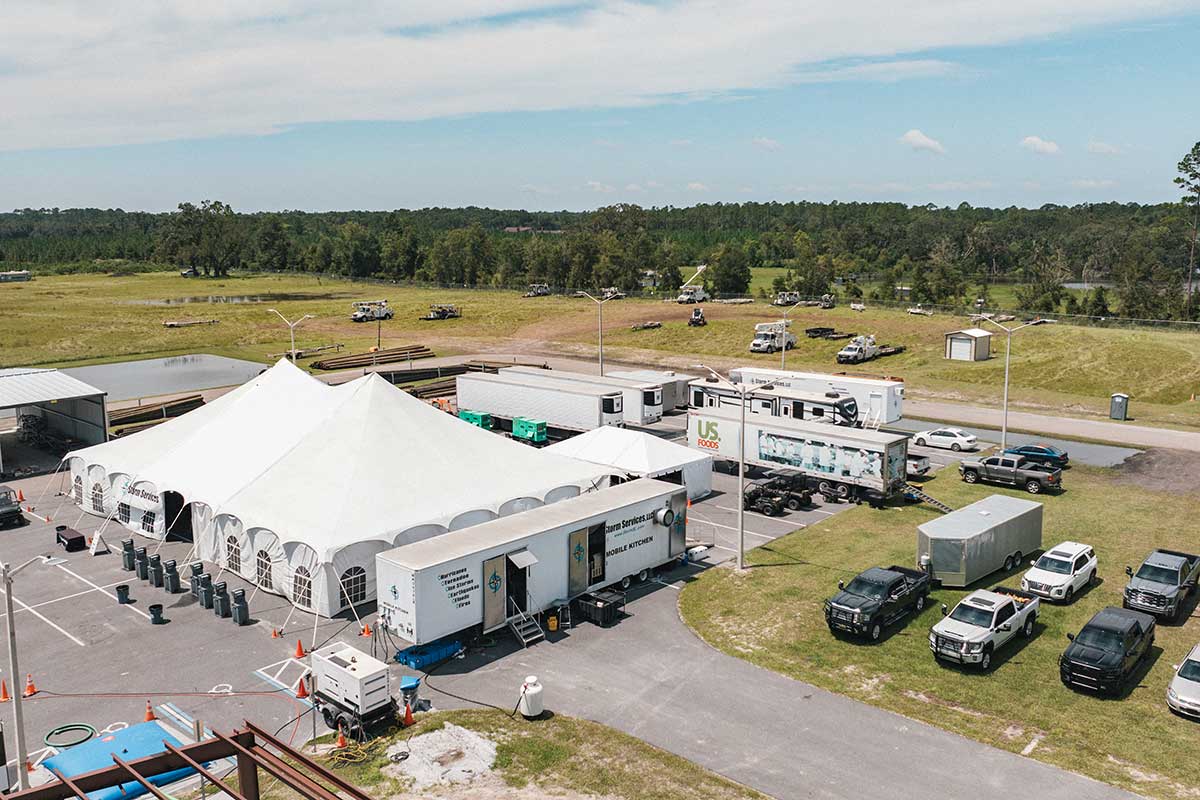An aerial view of a dining tent and catering trailer.
