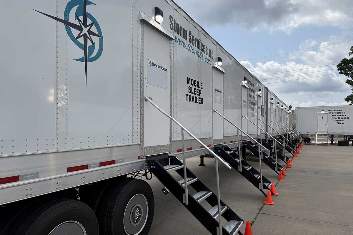 Multiple sleep trailers parked on site.