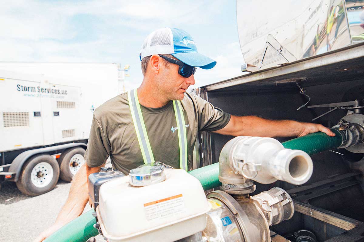 Pumping fresh water into bladder bags at a base camp.