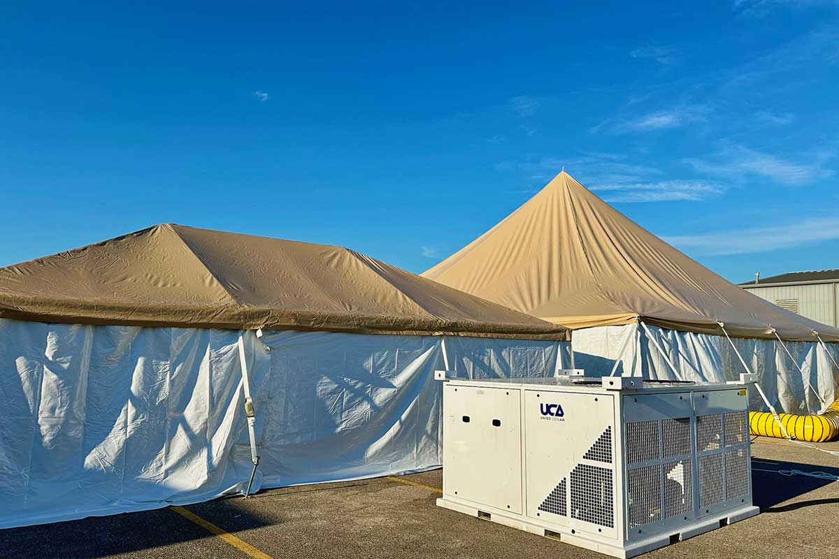 Climate control systems set up outside a base camp tent.